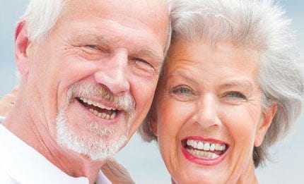 Two elderly people smiling