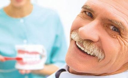 Old man smiles at the dentists